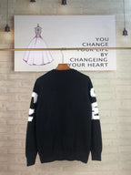 Alexander McQueen knit sweater in black with white QVE lettering on back