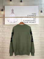 Alexander McQueen knit sweater in olive green with white QVE lettering on back