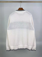 Cream knit sweater back view with ribbed crew neck and striped hem detail