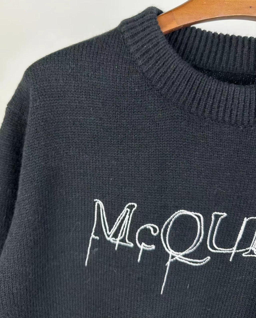 Dark knit sweater with ribbed crew neck and partial McQUEEN logo detail