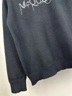 Dark knit sweater with crew neck and small McQUEEN logo on upper back