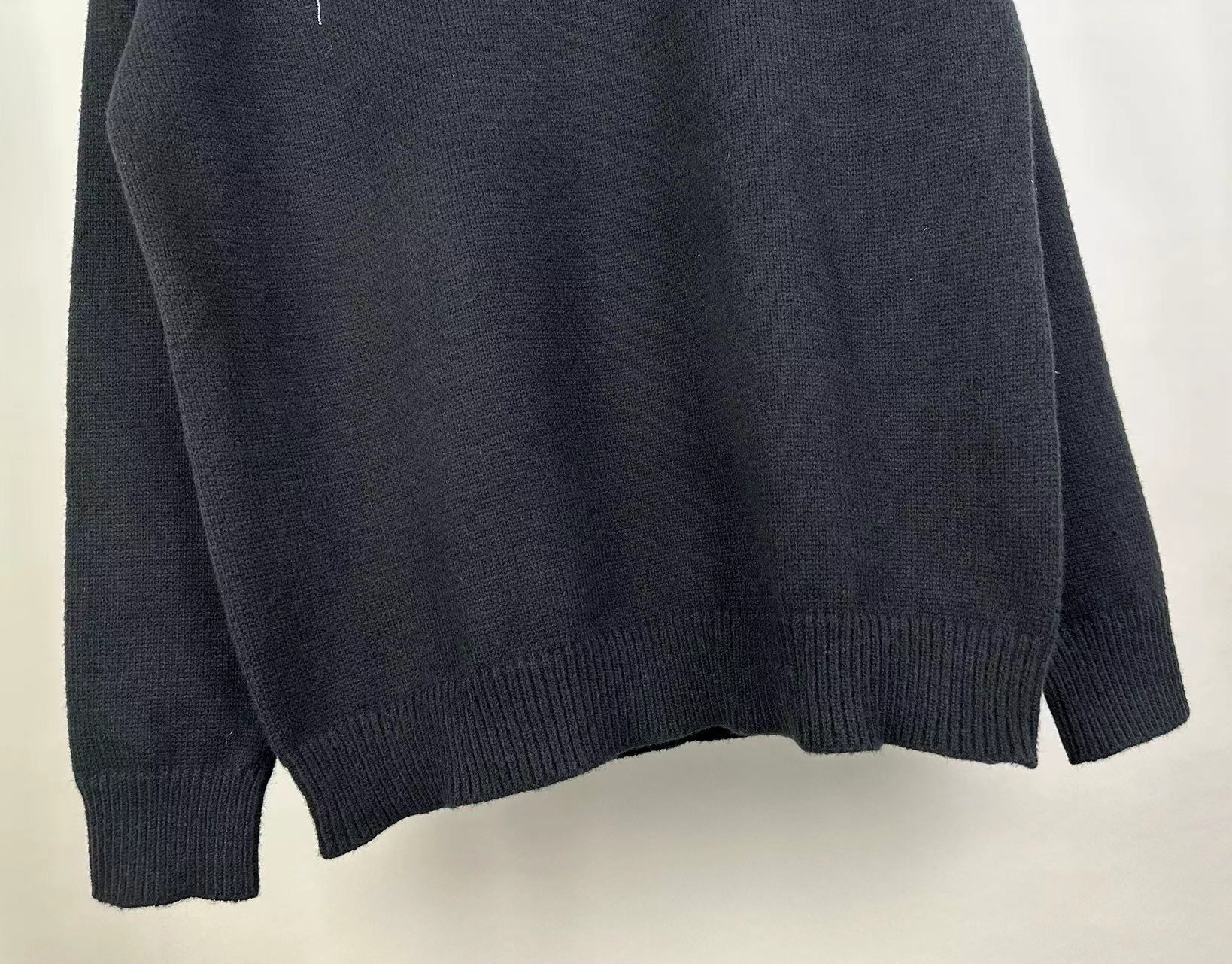 Dark knit sweater back with ribbed cuffs and hem, solid knit fabric