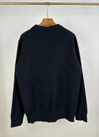 Dark knit sweater back view with crew neck and ribbed hem and cuffs