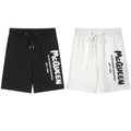 Drawstring shorts in black with white Alexander McQueen logo and cords