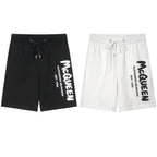 Drawstring shorts in black with white Alexander McQueen logo and cords
