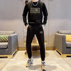 Maison Margiela black sweatshirt and track pants set with front graphic, worn with sneakers