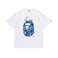 White graphic T-shirt with blue camouflage Bape logo on front