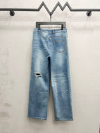Light blue distressed denim wide-leg jeans with ripped knee details