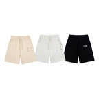 Shorts in beige, light gray, and black with drawstring and side seam pockets