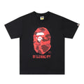 Bape black T-shirt with red camo ape face graphic and chest text logo