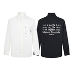 Two button-up shirts: white and black, with front logo graphics