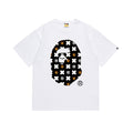 Bape white graphic T-shirt with black cartoon logo print on chest