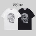 Alexander McQueen T-shirt pair: white and black crewneck with silver skull graphic