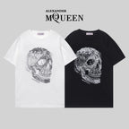 Alexander McQueen T-shirt pair: white and black crewneck with silver skull graphic