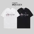 Two Alexander McQueen T-shirts in white and black with colorful splatter logo graphic
