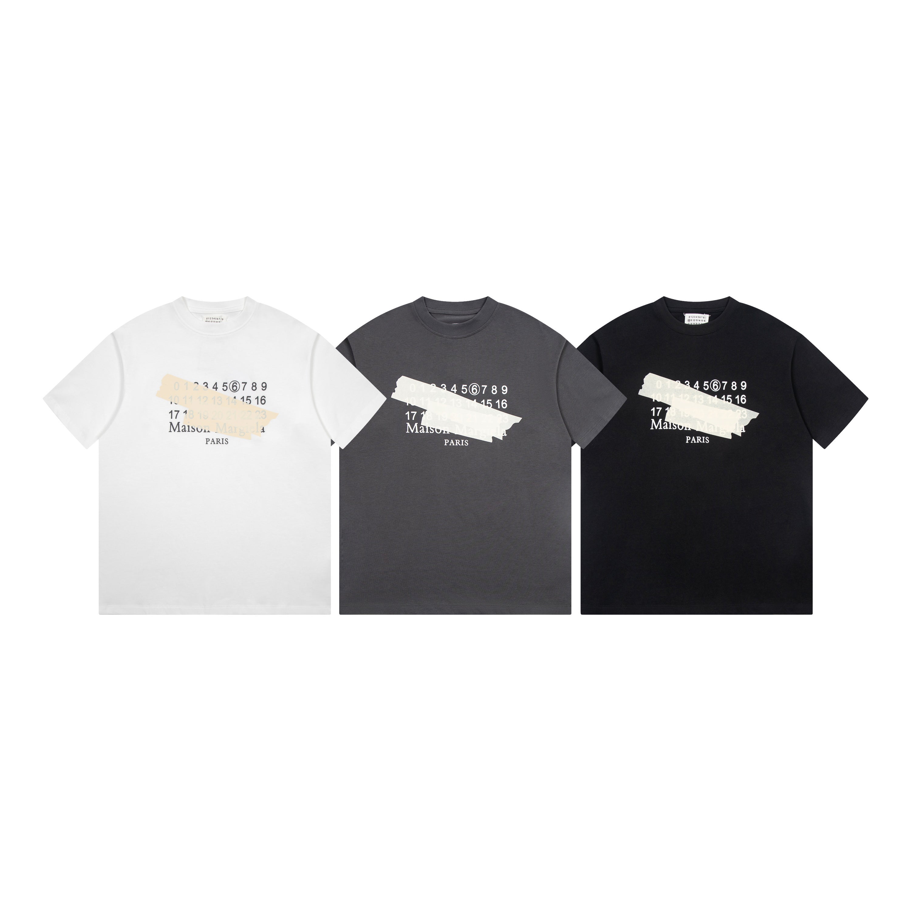 Three crew-neck T-shirts in white, charcoal, and black with Maison Margiela front graphics