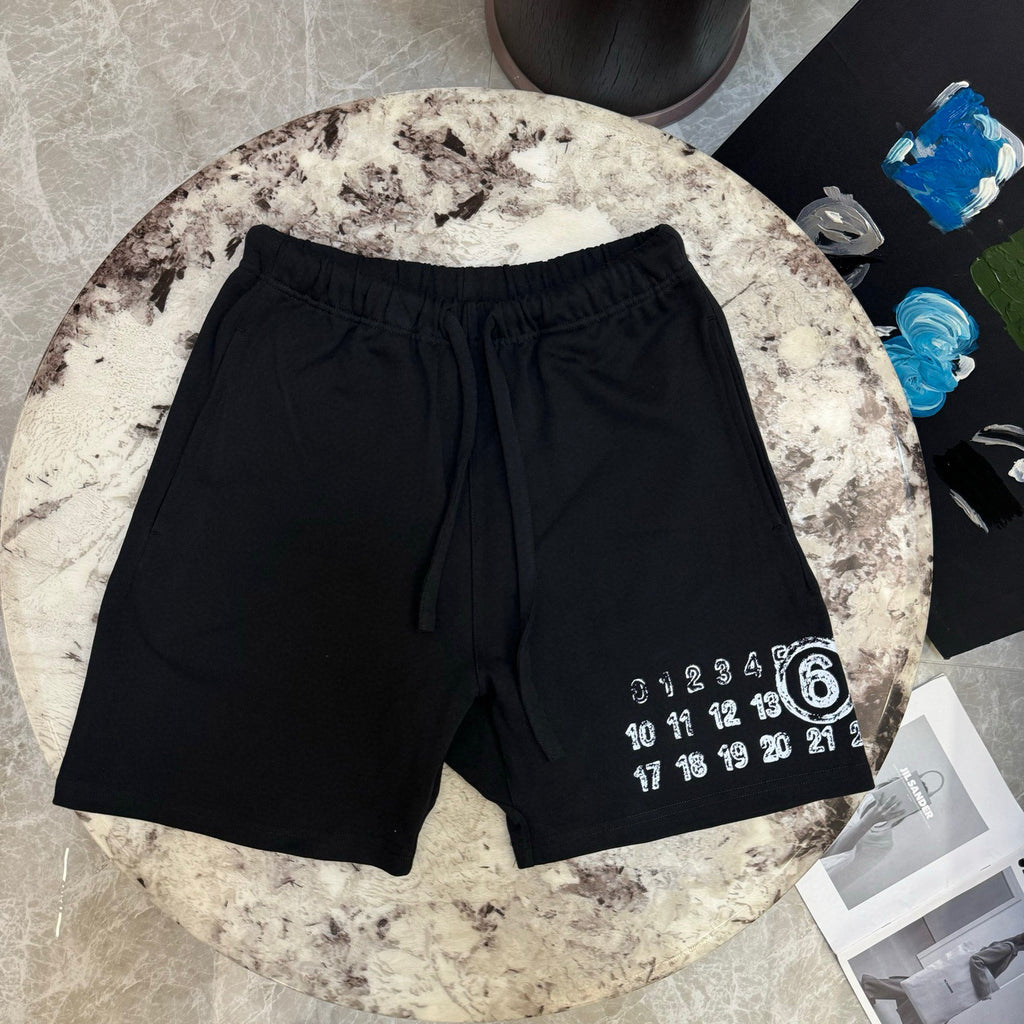 Black drawstring shorts with number graphic on right leg hem