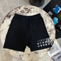 Black drawstring shorts with number graphic on right leg hem
