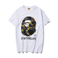 White T-shirt with camouflage ape face and BY BATHING APE logo