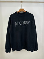 Dark knit sweater with crew neck and McQUEEN logo on front