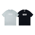 Two Maison Margiela T-shirts: light blue and black, white '6' logo