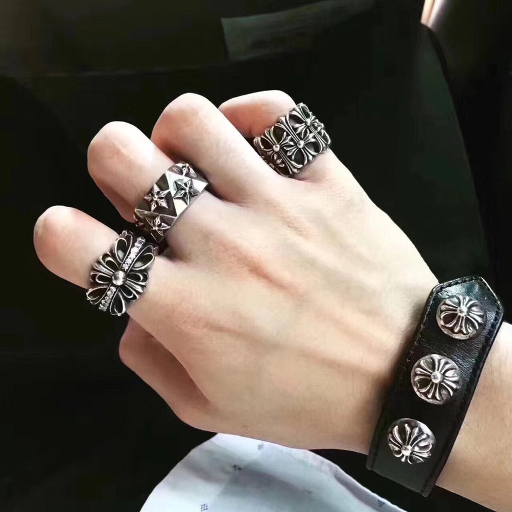 Silvertone floral rings on fingers with a matching cuff bracelet
