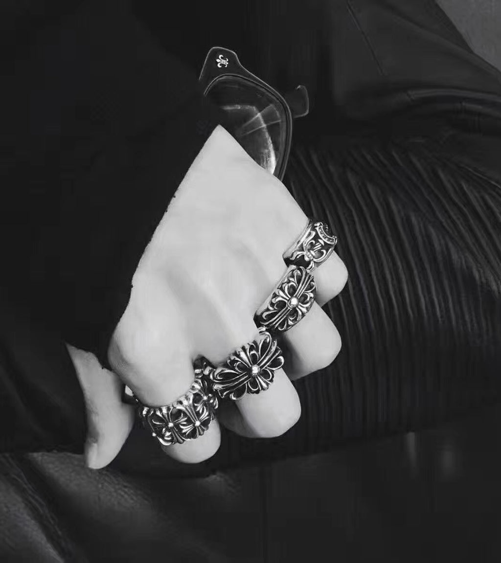 Silvertone floral rings stacked on fingers with a matching cuff bracelet
