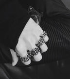 Silvertone floral rings stacked on fingers with a matching cuff bracelet