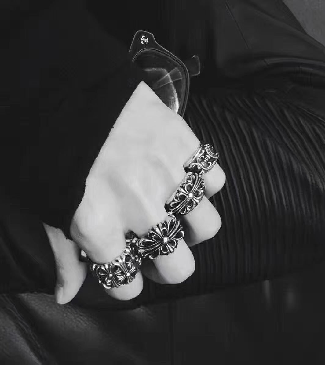 Silvertone floral rings stacked on fingers with a matching cuff bracelet
