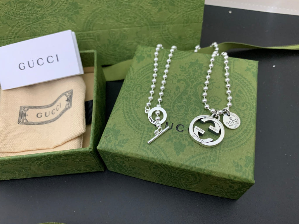 Silver charm necklace set with round GUCCI pendants and dangling letter charm