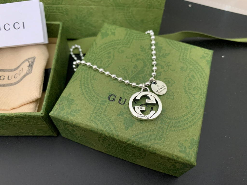 Silver chain necklace with round GUCCI logo pendant and heart tag
