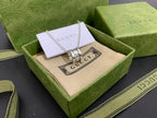 Silver Gucci pendant necklace with chain on beige insert in green gift box
