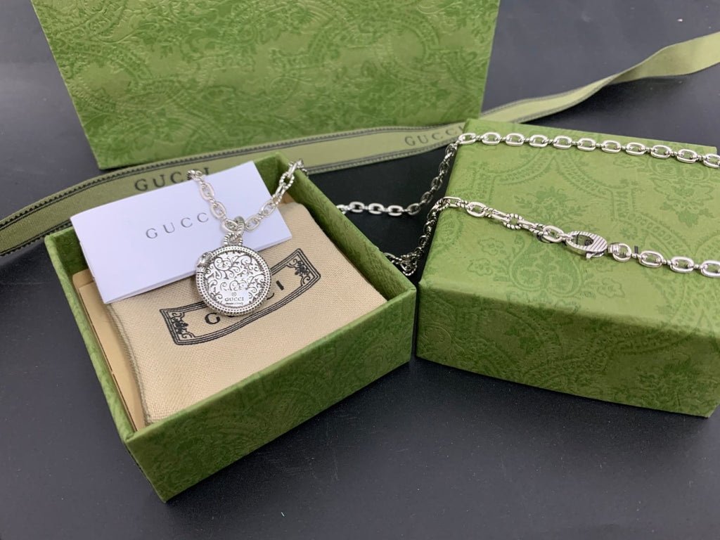 Gucci pendant necklace with silver round medallion and green accent in box