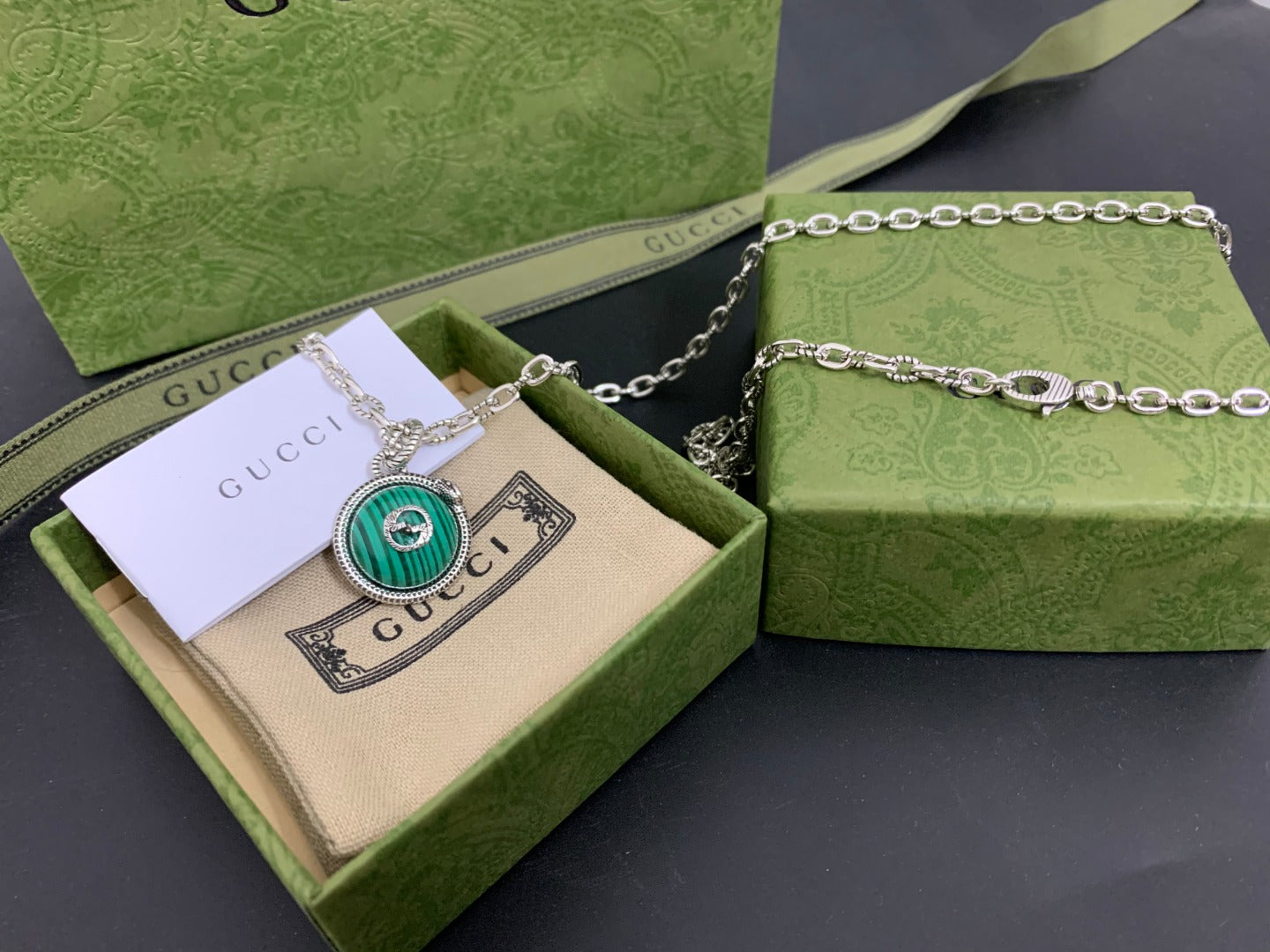 Gucci pendant necklace with green round medallion on silver chain in box
