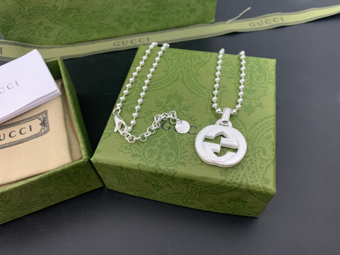 Silver-tone layered necklace with round interlocking G logo pendant and bead chains