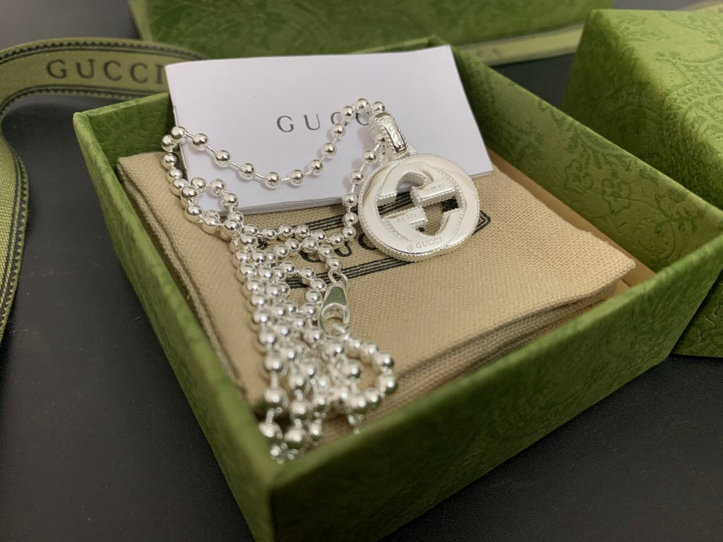 Silver-tone necklace with round interlocking G pendant and multi-strand beaded chains