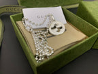 Silver-tone necklace with round interlocking G pendant and multi-strand beaded chains