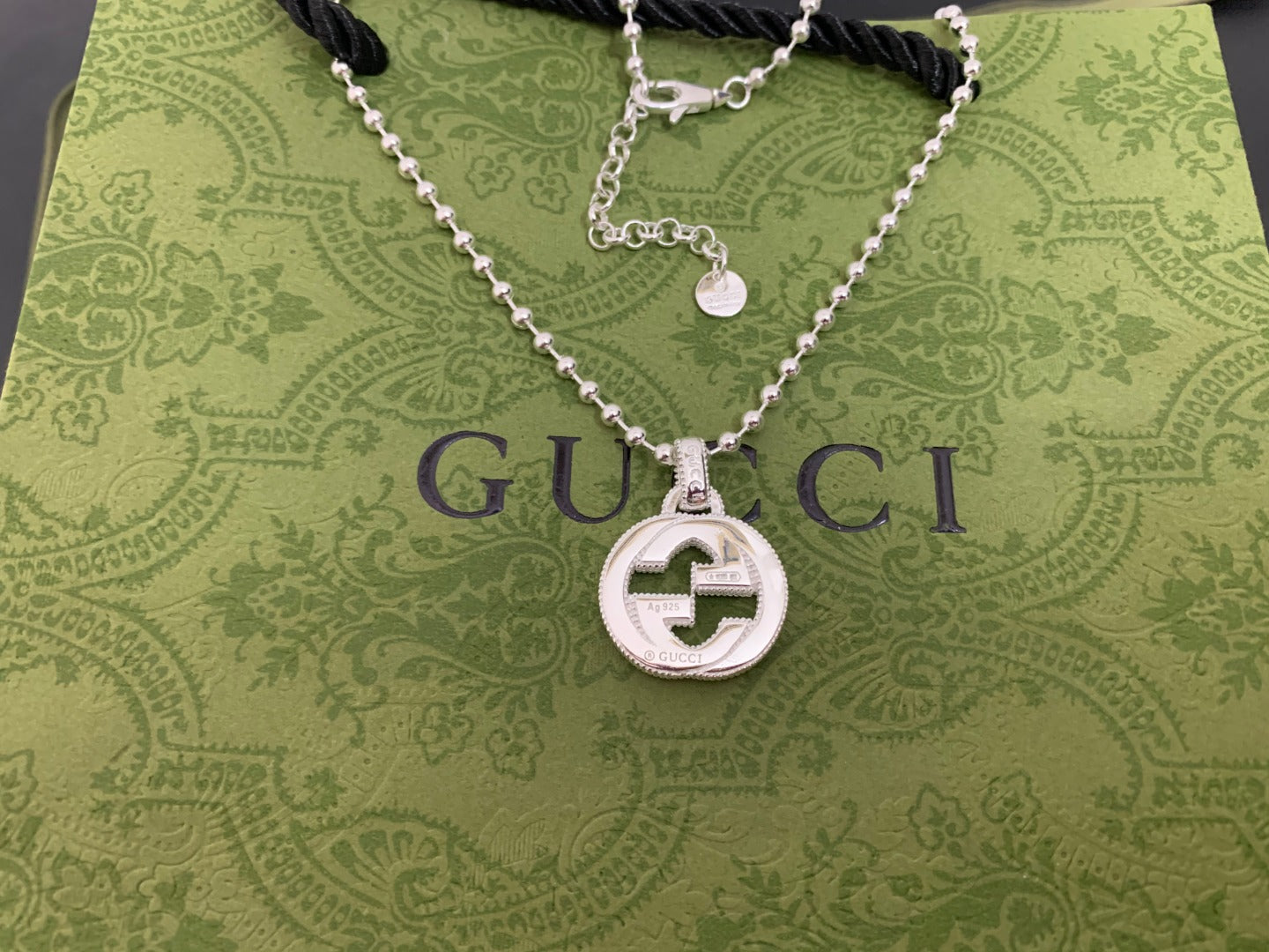 Silver-tone necklace with round interlocking G pendant and beaded double-layer chain