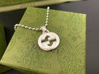 Silver-tone necklace with large round interlocking G logo pendant and beaded chain