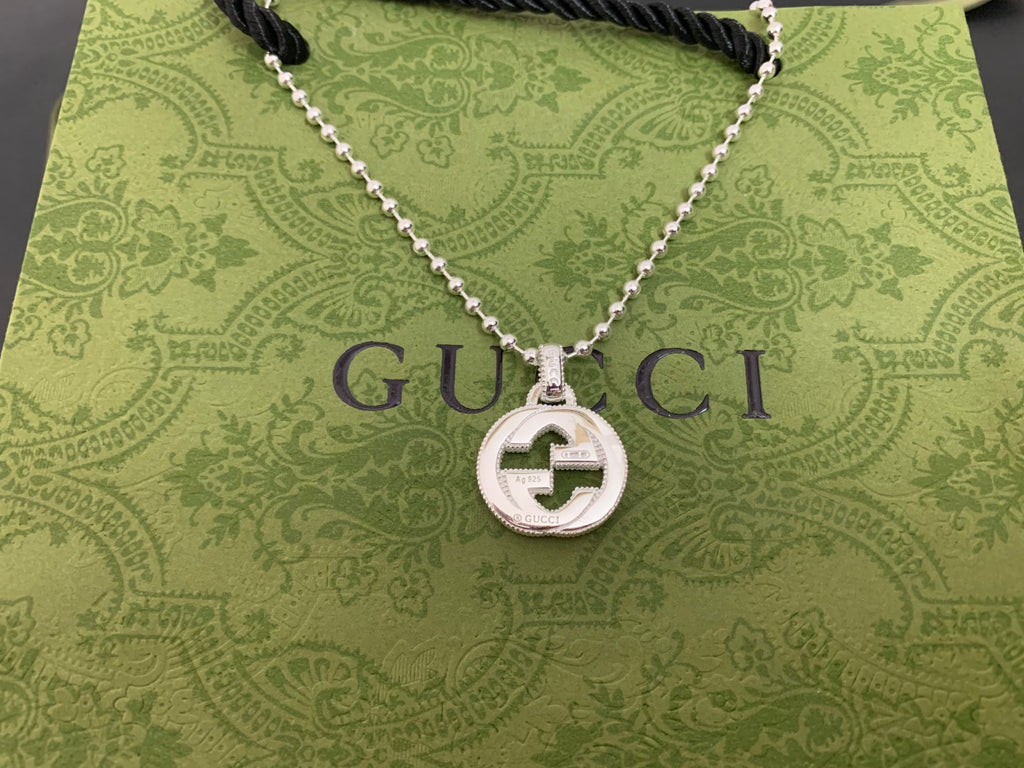 Silver-tone necklace with round interlocking G pendant on black cord