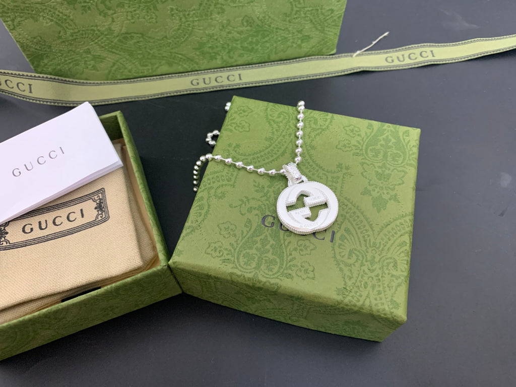 Silver-tone necklace with beaded chain and round interlocking G logo pendant
