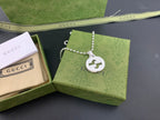 Silver-tone necklace with beaded chain and round interlocking G logo pendant