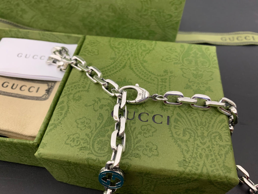 Silver chain strap with blue interlocking G charm and ring clasp
