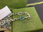 Silver chain strap with blue interlocking G medallions and clasp