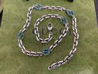 Silver chain strap with blue interlocking G medallions and rings