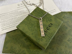 Gucci necklace with silver chain and rectangular GG charm pendant