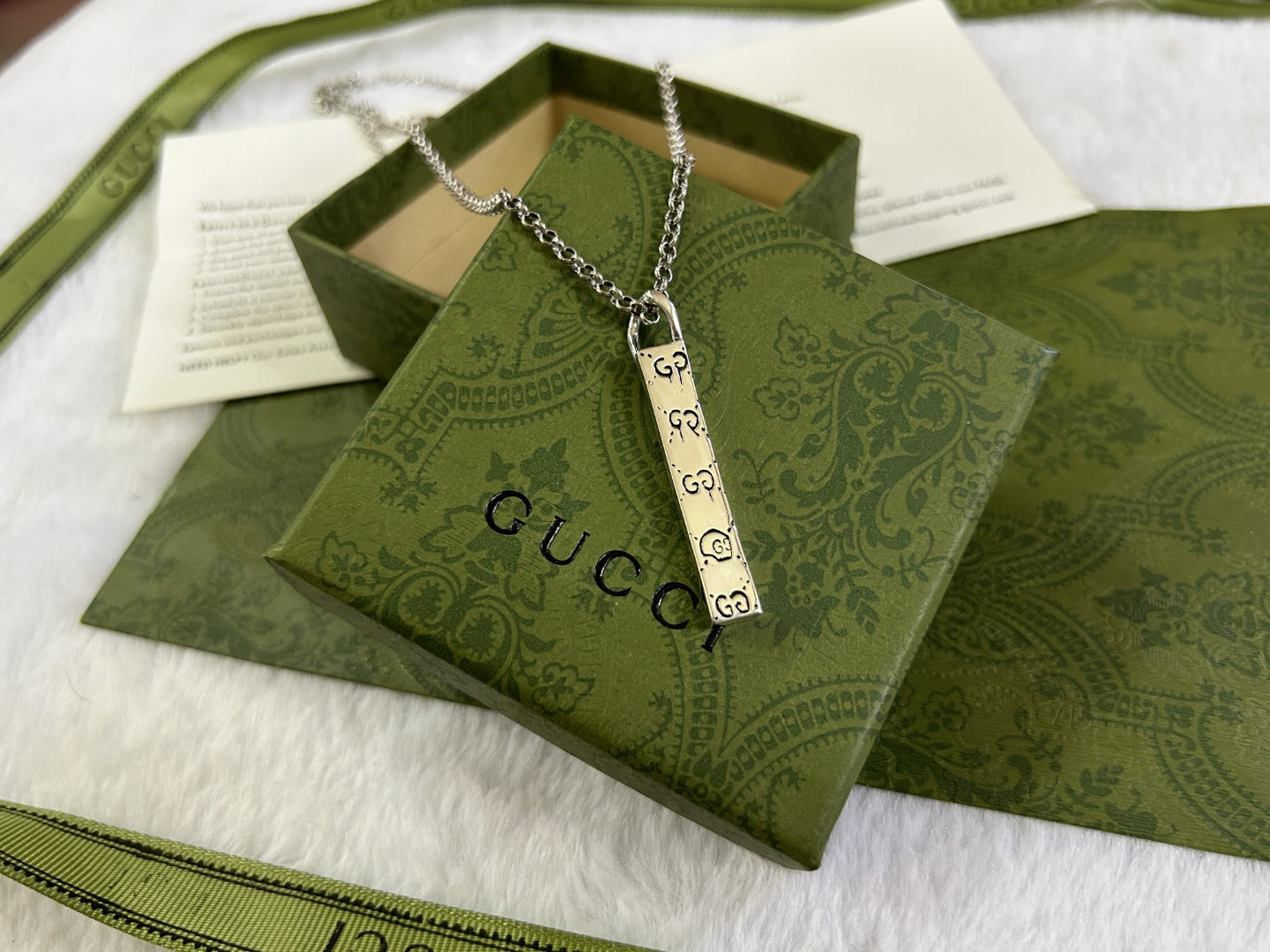 Gucci necklace with silver chain and hanging long rectangular GG charm pendant