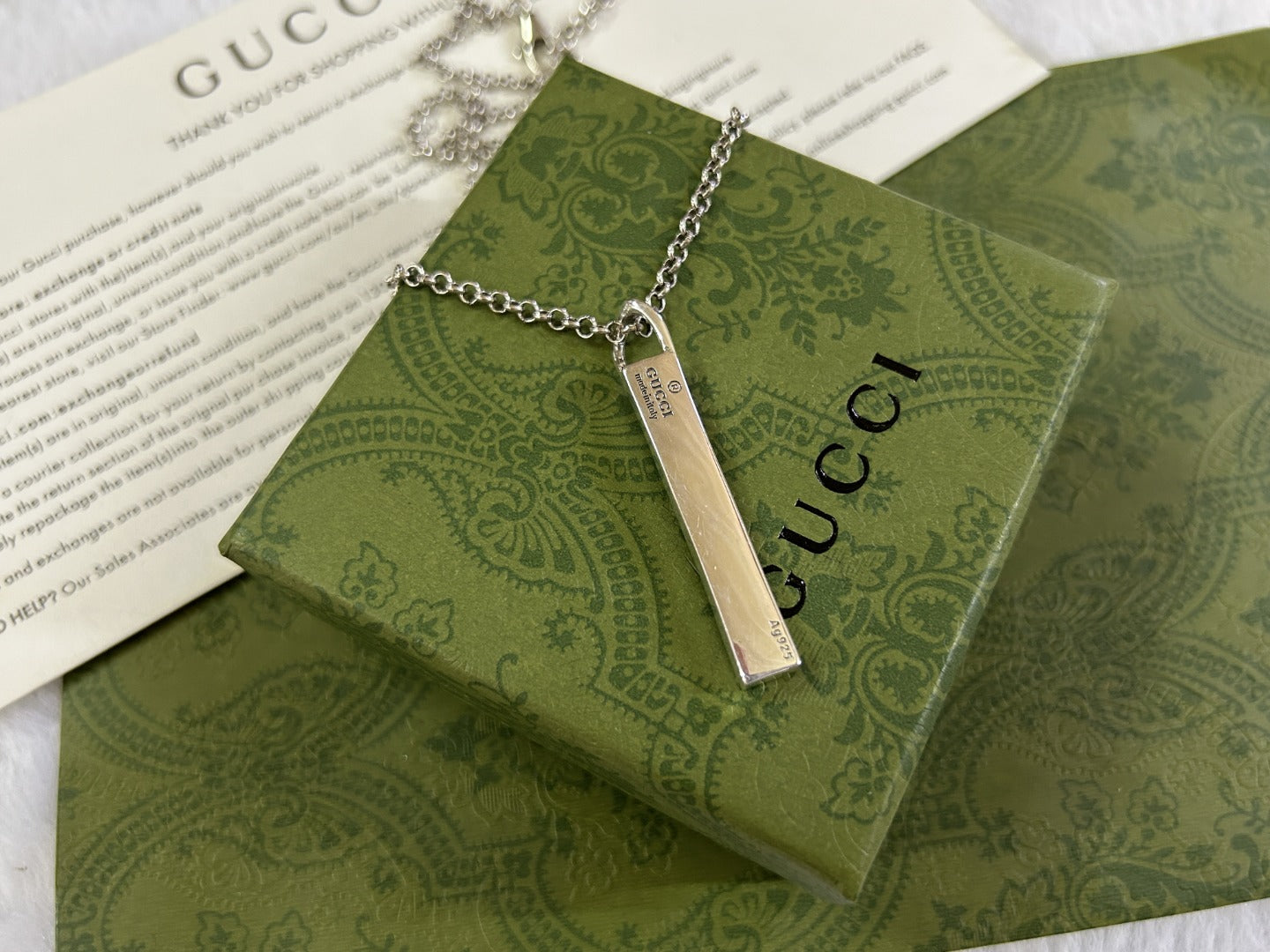 Gucci necklace with silver chain and long rectangular GG pendant charm
