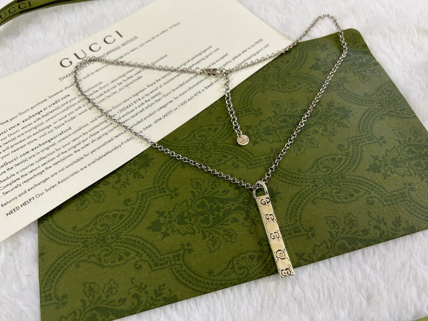 Gucci necklace with silver chain and multiple GG charms with round tag