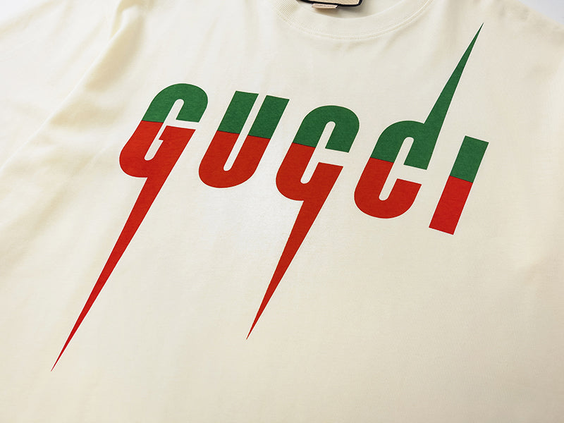 Cream Gucci logo T-shirt graphic with green text and red drips